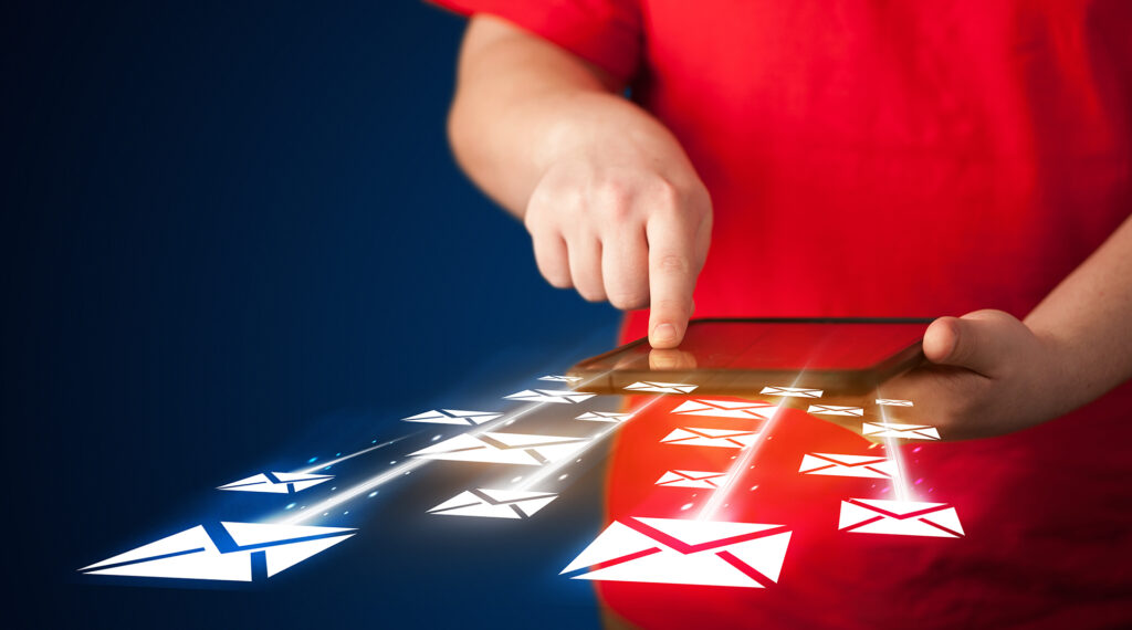 hand holding tablet and sending email icons